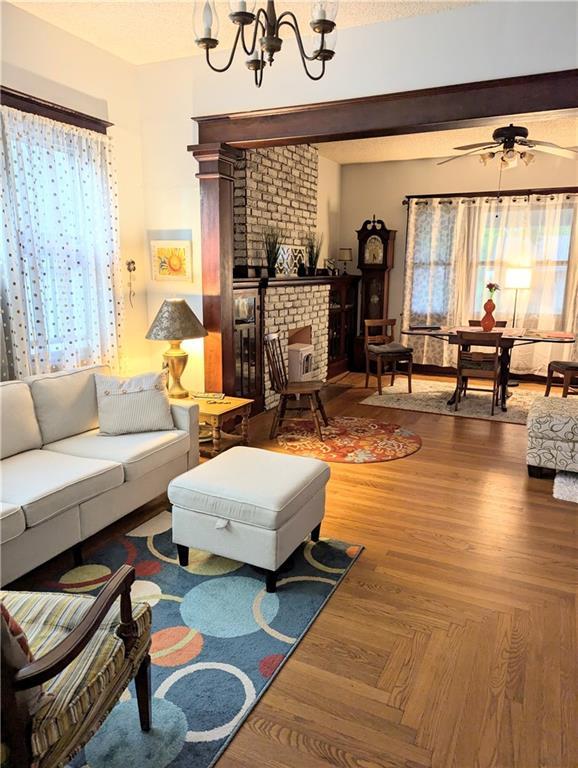 429 N 12th St, Fredonia, KS 66736 - living area with a chandelier, a fireplace, and a ceiling fan