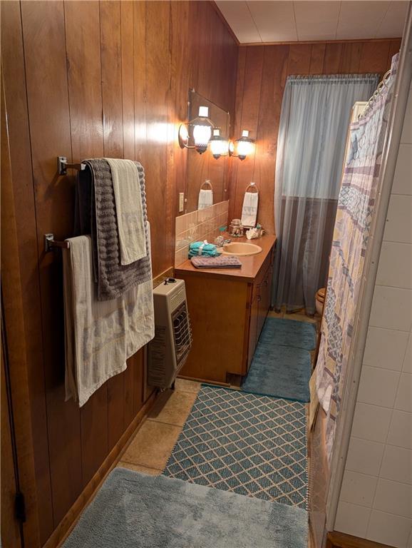 429 N 12th St, Fredonia, KS 66736 - full bathroom with vanity and wood walls