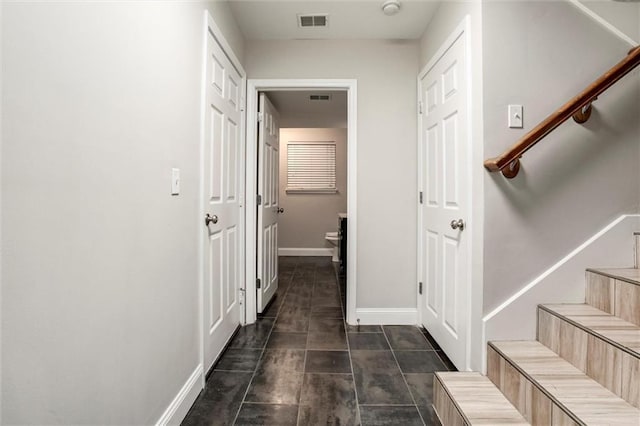 7132 Woodstock St, Shawnee, KS 66218 - hall with stairs, baseboards, and dark tile patterned flooring