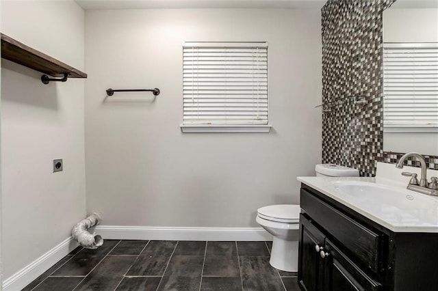 7132 Woodstock St, Shawnee, KS 66218 - bathroom featuring vanity, toilet, and baseboards