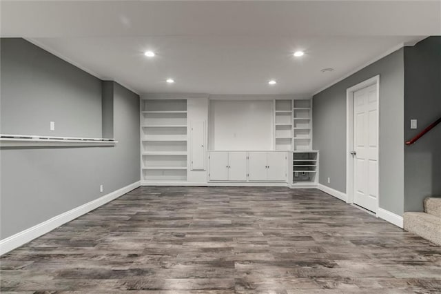 7132 Woodstock St, Shawnee, KS 66218 - below grade area featuring recessed lighting, baseboards, built in shelves, dark wood-style floors, and crown molding