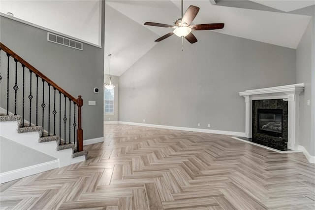 7132 Woodstock St, Shawnee, KS 66218 - unfurnished living room with high vaulted ceiling, a ceiling fan, stairs, baseboards, and a fireplace