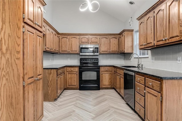 7132 Woodstock St, Shawnee, KS 66218 - kitchen featuring appliances with stainless steel finishes, a sink, lofted ceiling, brown cabinetry, and backsplash