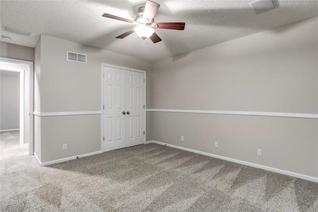 7132 Woodstock St, Shawnee, KS 66218 - unfurnished bedroom featuring carpet, baseboards, a textured ceiling, a ceiling fan, and a closet