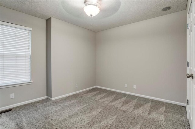 7132 Woodstock St, Shawnee, KS 66218 - carpeted spare room featuring a textured ceiling, a ceiling fan, and baseboards
