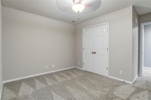 7132 Woodstock St, Shawnee, KS 66218 - unfurnished bedroom with carpet, baseboards, a closet, a textured ceiling, and ceiling fan