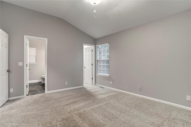 7132 Woodstock St, Shawnee, KS 66218 - unfurnished bedroom featuring vaulted ceiling, carpet floors, baseboards, and ensuite bathroom