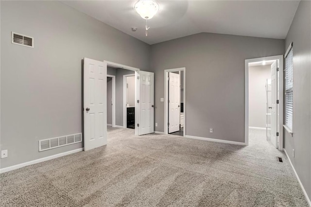 7132 Woodstock St, Shawnee, KS 66218 - unfurnished bedroom with lofted ceiling, carpet floors, baseboards, a spacious closet, and connected bathroom