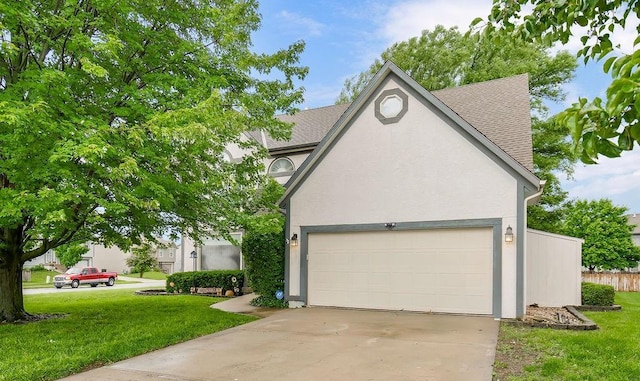 600 N Oak St, Gardner, KS 66030 - view of front facade featuring stucco siding, a shingled roof, concrete driveway, and an attached garage