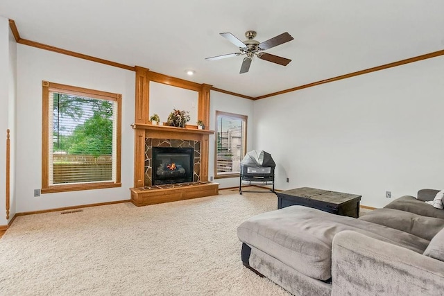 600 N Oak St, Gardner, KS 66030 - carpeted living area with ornamental molding, a ceiling fan, and a tile fireplace