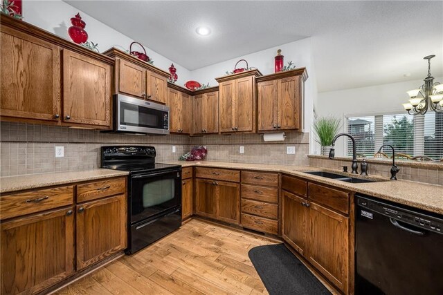 14165 Ashbury Ct, Basehor, KS 66007 - kitchen featuring black appliances, a sink, a chandelier, light wood-type flooring, and backsplash