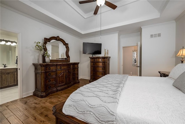 14165 Ashbury Ct, Basehor, KS 66007 - bedroom featuring a tray ceiling, wood finished floors, ornamental molding, connected bathroom, and ceiling fan
