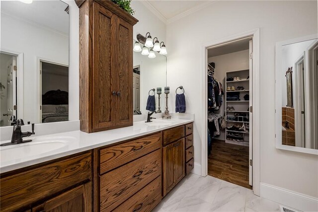 14165 Ashbury Ct, Basehor, KS 66007 - full bath with crown molding, double vanity, a walk in closet, and marble finish flooring