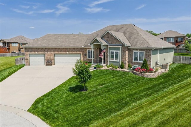 14165 Ashbury Ct, Basehor, KS 66007 - single story home with driveway, a garage, and brick siding