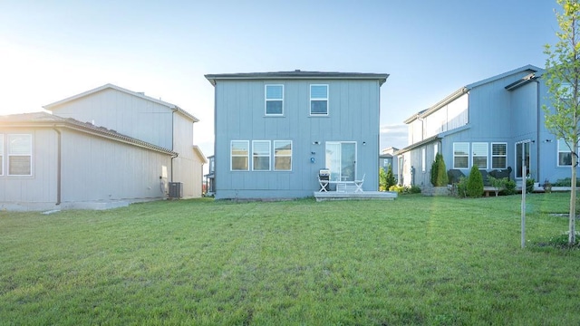 13333 W 180th St, Overland Park, KS 66013 - rear view of house with a lawn, board and batten siding, and cooling unit