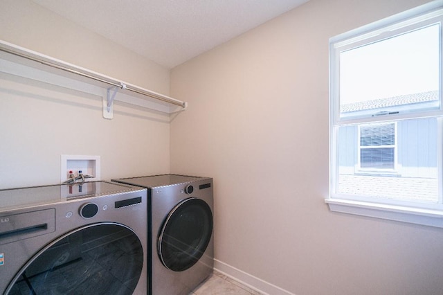 13333 W 180th St, Overland Park, KS 66013 - laundry room featuring washing machine and dryer, baseboards, and light tile patterned floors