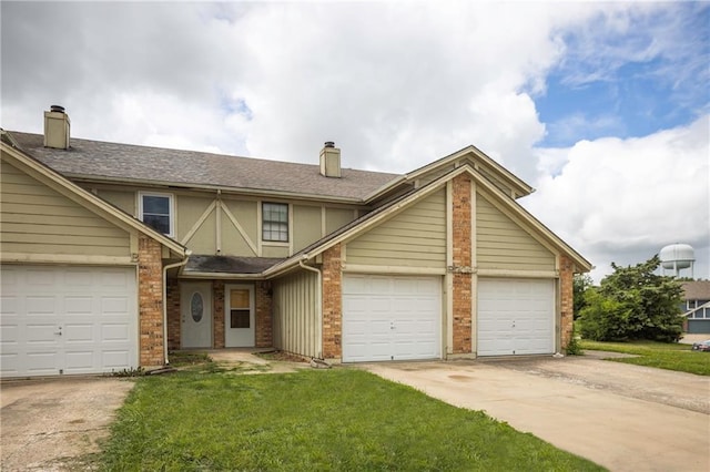 706 Cedar Dr Unit C, Warrensburg, MO 64093 - view of front of house featuring a chimney, driveway, and a front yard
