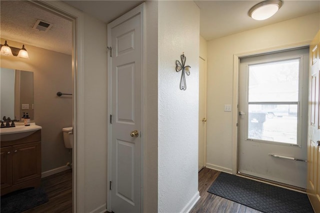 706 Cedar Dr Unit C, Warrensburg, MO 64093 - doorway with dark wood-style flooring and baseboards