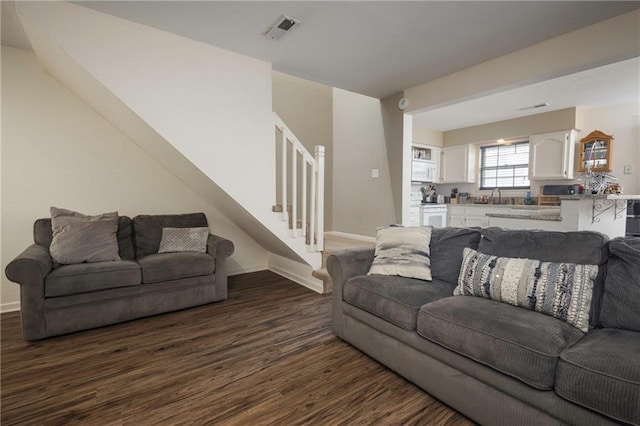 706 Cedar Dr Unit C, Warrensburg, MO 64093 - living area featuring stairway and dark wood finished floors