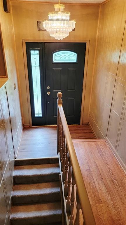 1045 Yale Rd, Mapleton, KS 66754 - stairway with wood finished floors and a chandelier