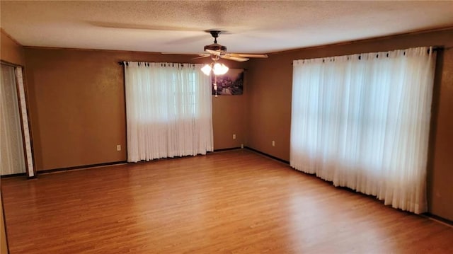 1045 Yale Rd, Mapleton, KS 66754 - empty room with a ceiling fan, light wood-style floors, baseboards, and a textured ceiling