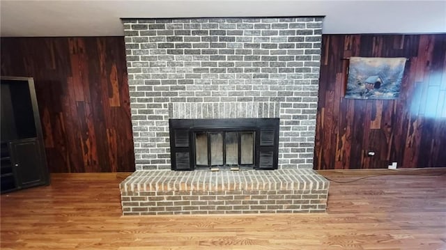 1045 Yale Rd, Mapleton, KS 66754 - detailed view of wooden walls, a fireplace, and wood finished floors