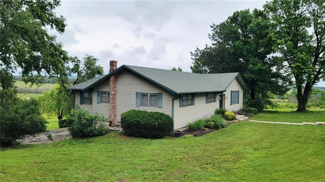 1045 Yale Rd, Mapleton, KS 66754 - view of property exterior featuring a chimney and a lawn