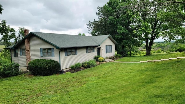 1045 Yale Rd, Mapleton, KS 66754 - view of property exterior with a chimney and a yard