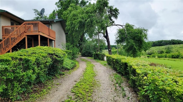 1045 Yale Rd, Mapleton, KS 66754 - view of yard featuring a deck, driveway, and stairway