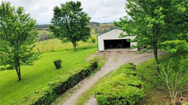 1045 Yale Rd, Mapleton, KS 66754 - view of yard featuring a detached garage, driveway, and an outbuilding