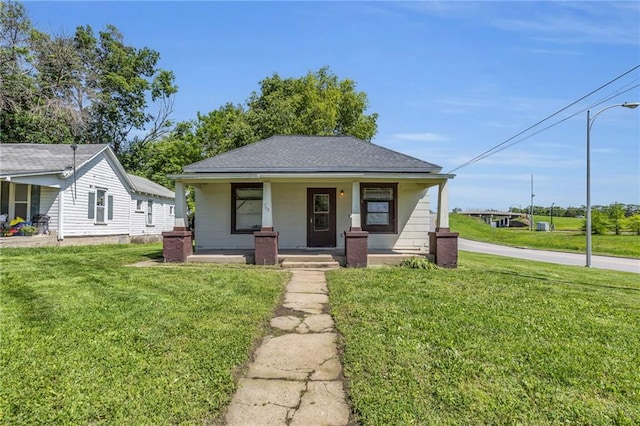 700 Parker Ave, Osawatomie, KS 66064 - view of front of property featuring a porch, a front lawn, and roof with shingles