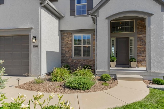 21222 W 46th Ter, Shawnee, KS 66218 - property entrance featuring stone siding, stucco siding, and a garage