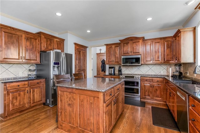 21222 W 46th Ter, Shawnee, KS 66218 - kitchen featuring stainless steel appliances, a center island, dark wood-type flooring, dark stone countertops, and decorative backsplash