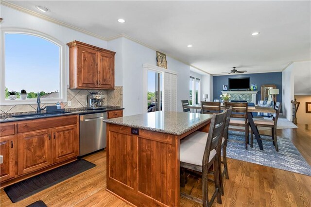 21222 W 46th Ter, Shawnee, KS 66218 - kitchen with stainless steel dishwasher, light wood-style floors, ceiling fan, a breakfast bar, and recessed lighting
