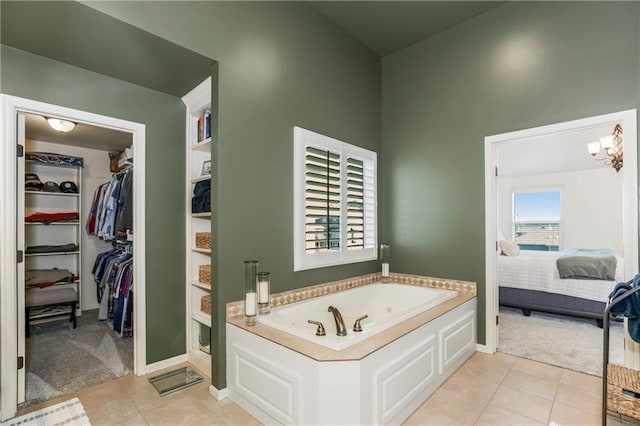 21222 W 46th Ter, Shawnee, KS 66218 - ensuite bathroom featuring a whirlpool tub, a walk in closet, and tile patterned floors