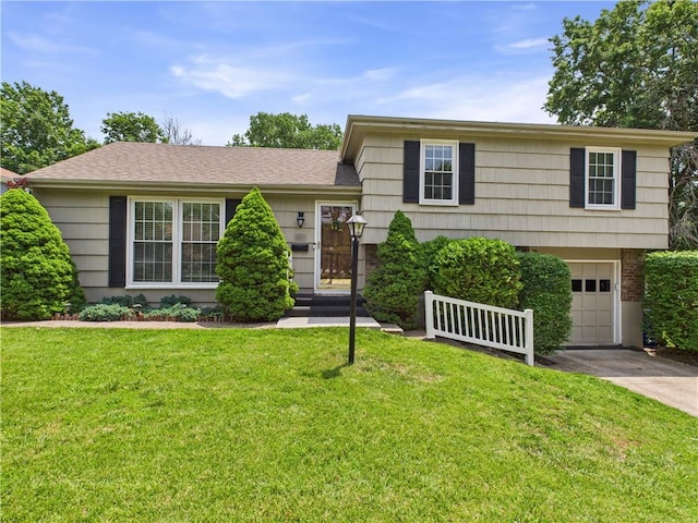 8101 E 133rd Ter, Grandview, MO 64030 - tri-level home featuring driveway, an attached garage, and a front yard