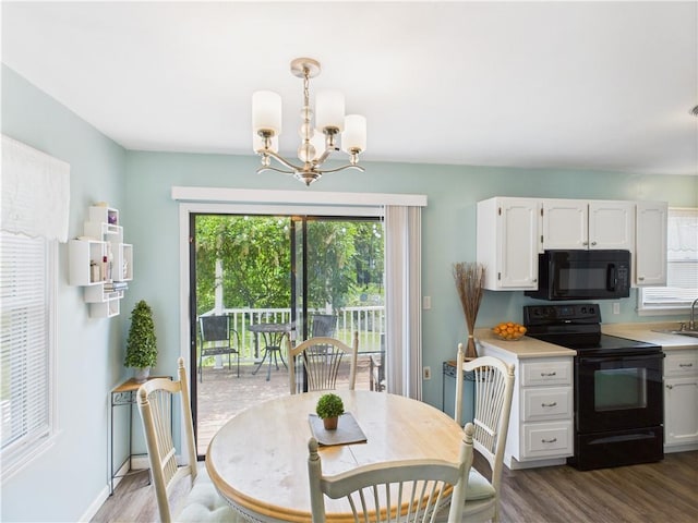 8101 E 133rd Ter, Grandview, MO 64030 - dining room with a chandelier, dark wood-style floors, and baseboards