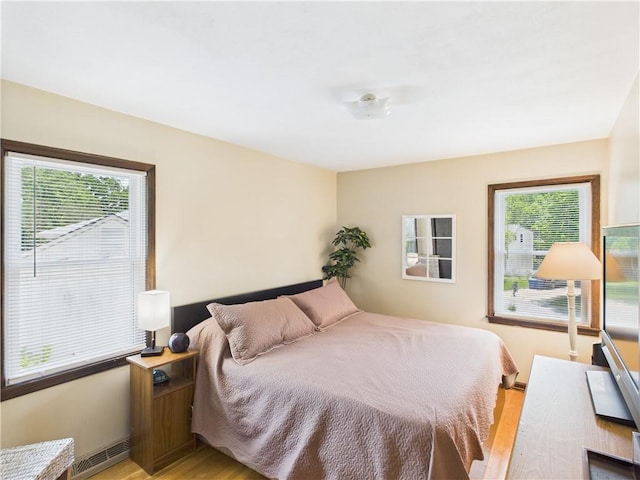 8101 E 133rd Ter, Grandview, MO 64030 - bedroom featuring light wood-style floors and baseboards
