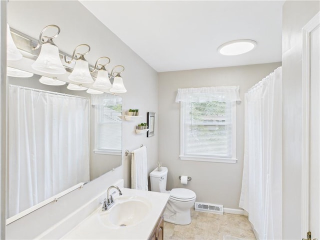 8101 E 133rd Ter, Grandview, MO 64030 - bathroom with toilet, vanity, plenty of natural light, and baseboards