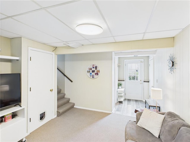 8101 E 133rd Ter, Grandview, MO 64030 - living room featuring stairway, a paneled ceiling, baseboards, and carpet flooring