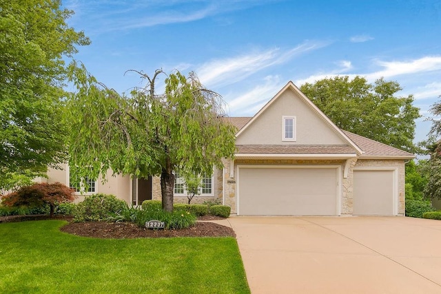 12337 Westgate St, Overland Park, KS 66213 - view of front of property with a garage, concrete driveway, a front yard, stucco siding, and stone siding