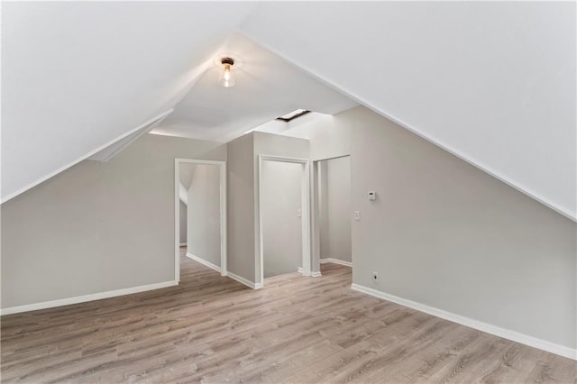 803 E College St, Independence, MO 64050 - bonus room featuring wood finished floors, vaulted ceiling, and baseboards