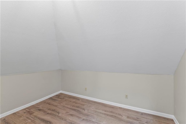 803 E College St, Independence, MO 64050 - bonus room with wood finished floors, vaulted ceiling, and baseboards