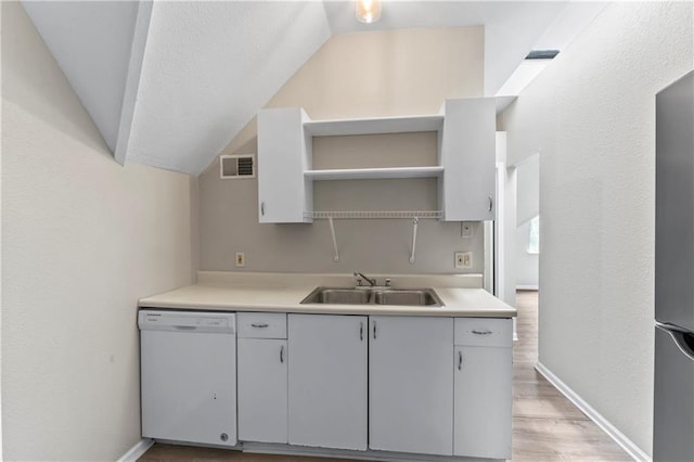 803 E College St, Independence, MO 64050 - kitchen featuring white dishwasher, open shelves, a sink, lofted ceiling, and light countertops