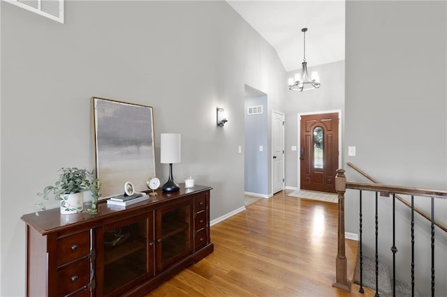 16910 Juniper Dr, Basehor, KS 66007 - foyer featuring high vaulted ceiling, light wood-style flooring, and a chandelier