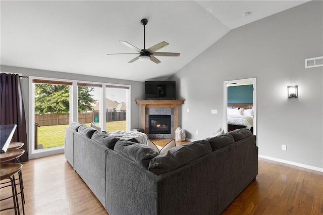 16910 Juniper Dr, Basehor, KS 66007 - living room featuring ceiling fan, lofted ceiling, wood finished floors, and a fireplace