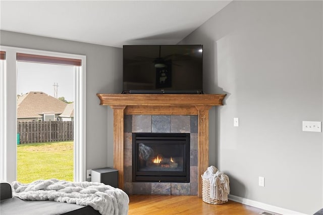 16910 Juniper Dr, Basehor, KS 66007 - detailed view of a tile fireplace, wood finished floors, and ceiling fan