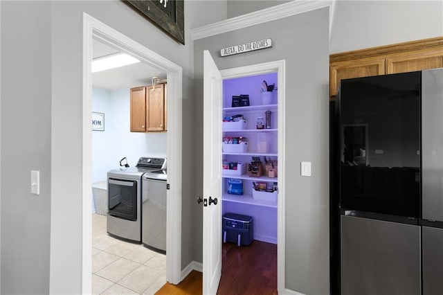 16910 Juniper Dr, Basehor, KS 66007 - washroom with washer and dryer, cabinet space, and light wood finished floors