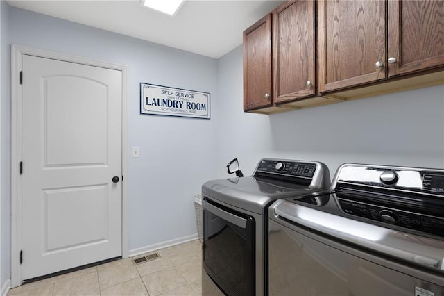 16910 Juniper Dr, Basehor, KS 66007 - laundry room featuring cabinet space, washing machine and dryer, and light tile patterned floors