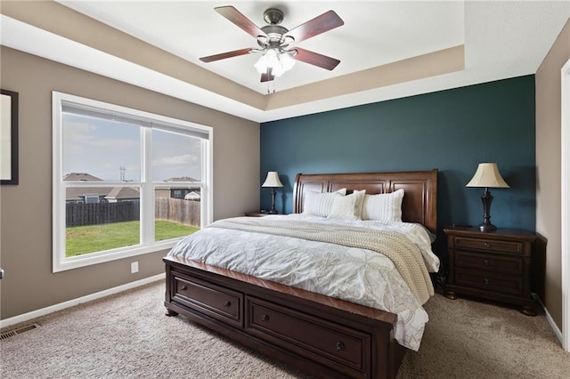 16910 Juniper Dr, Basehor, KS 66007 - bedroom with light colored carpet, a tray ceiling, and a ceiling fan